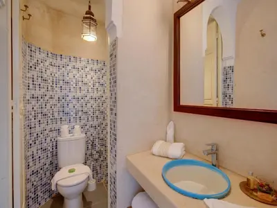 a bathroom with a toilet and a sink and a mirror at Riad Princesse Du Désert & Spa in Marrakech