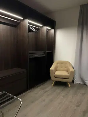 a living room with a chair and a closet at Luxury Palm Villa in Marrakech