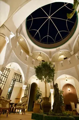 a building with a ceiling with a tree in it at La Claire Fontaine in Marrakech