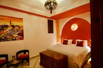a hotel room with a bed and a table at La Claire Fontaine in Marrakech