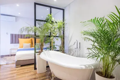 a bathroom with potted plants and a bath tub at Best for group, 5 min from medina in Marrakech