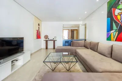 a living room with a couch and a tv at Best for group, 5 min from medina in Marrakech