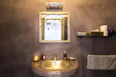 a bathroom with a sink and a mirror at Riad Hissan in Marrakech