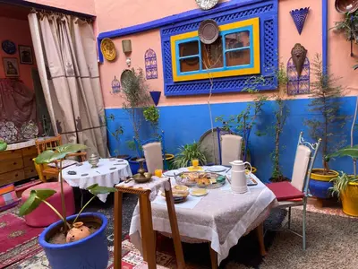 a room with a table with food on it at ALMARKAB Riad in Marrakech