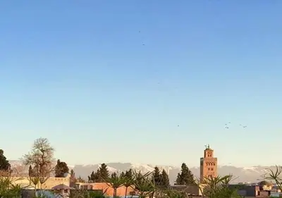 a view of a city with a clock tower at ALMARKAB Riad in Marrakech