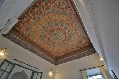 an ornate ceiling in a building with a mosaic at Riad 5 GÉNÉRATIONS in Marrakech