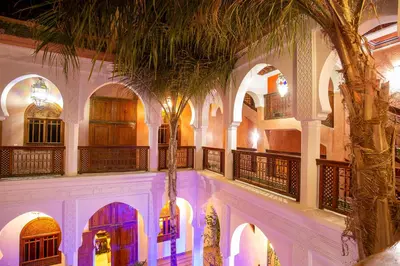 a courtyard in a building with a palm tree at Riad Agdal Royal & Spa in Marrakech
