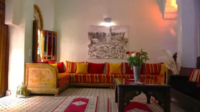 a living room with a red and yellow couch at Riad Agdal Royal & Spa in Marrakech