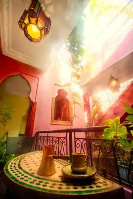a table with vases sitting on top of a balcony at Riad Roxanne in Marrakech