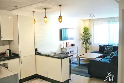 a kitchen and living room with a couch and a table at AiM HOUSE in Marrakech