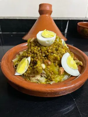 a bowl of food with beans and eggs on it at Héritage Lalla Aicha Hotel & Spa in Marrakech