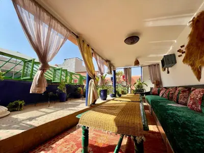 a living room with a couch and some windows at Héritage Lalla Aicha Hotel & Spa in Marrakech