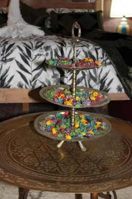 a table with two tiered plates on top of a table at Riad la medersa in Marrakech