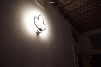 a light on a wall with a butterfly on it at Riad Rayan's Guests in Marrakech