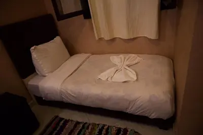 a small bed with a bow on top of it at Riad Rayan's Guests in Marrakech