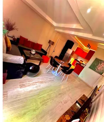 a living room with a couch and a table and chairs at Comme à la maison, en plein coeur de Marrakech in Marrakech