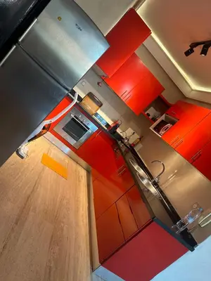 an overhead view of a kitchen with orange cabinets at Comme à la maison, en plein coeur de Marrakech in Marrakech