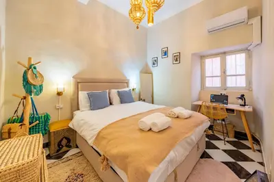 a bedroom with a large bed with towels on it at Dar Noubti in Marrakech
