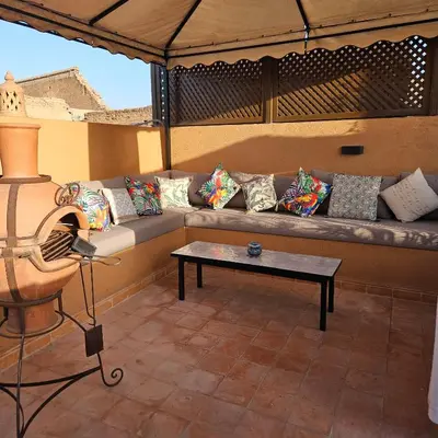 a living room with a couch and a table at Riad le Voile d'Orient in Marrakech