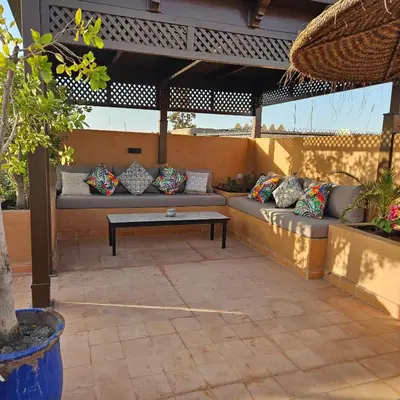 a patio with a couch and a coffee table at Riad le Voile d'Orient in Marrakech