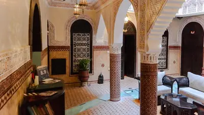 a living room with a couch and a table at Riad Hôtel Marraplace in Marrakech