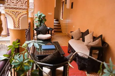 a living room with a couch and some chairs at Riad Hôtel Marraplace in Marrakech