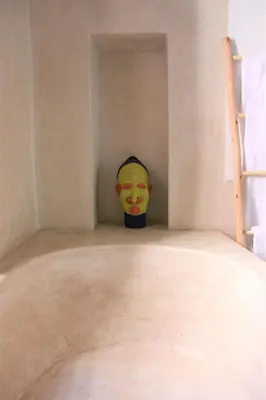 a mask sitting in a corner of a room at Riad El Ouarda in Marrakech