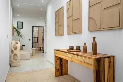 a room with a wooden counter with vases on the wall at Riad La Croix Berbere Deluxe in Marrakech