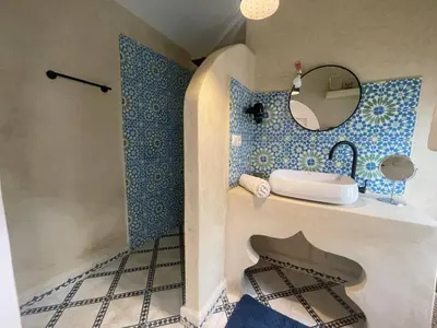 a bathroom with a sink and a mirror at RIAD ZEFYR in Marrakech