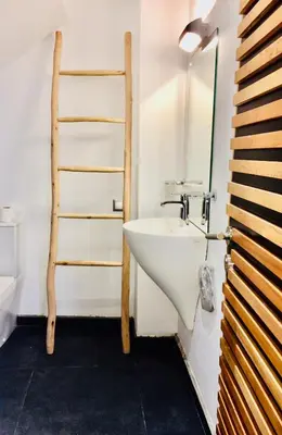 a bathroom with a white sink and a ladder at Riad Love B&B in Marrakech