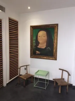 a room with two chairs and a painting and a table at Riad Love B&B in Marrakech