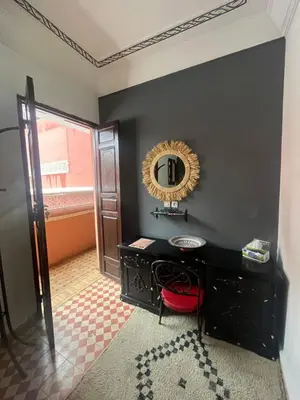 a bathroom with a mirror and a black wall at Riad Naya in Marrakech