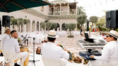 a group of musicians playing music in a courtyard at Palmeraie Golf Suites By Pickalbatros in Marrakech
