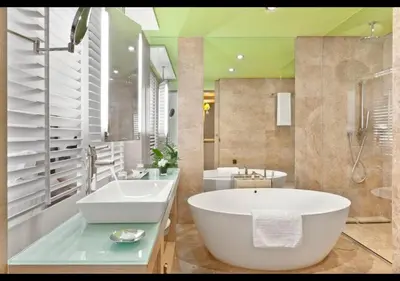 a bathroom with a large tub and a sink at Palmeraie Golf Suites By Pickalbatros in Marrakech