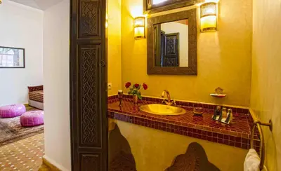 a bathroom with a sink and a mirror at Riad Dabachi in Marrakech