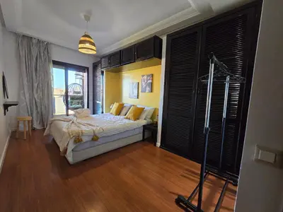 a bedroom with a bed and a large window at Cosy Bagatelle Houses 1 & 2 in Marrakech