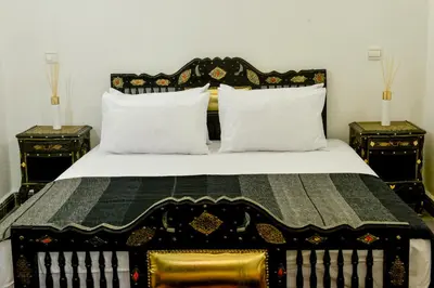 a bedroom with a bed with two night stands at Casa De Marrakech Riad Guest House in Marrakech