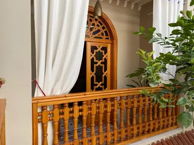 a balcony with a wooden railing and a window at RIAD SHAJARA in Marrakech