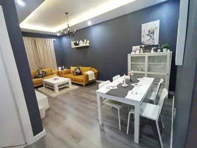 a living room with a white table and a couch at La saphir marrakech in Marrakech