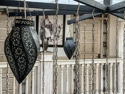 a porch with two vases hanging from a railing at Riad Wazani Square & SPA in Marrakech