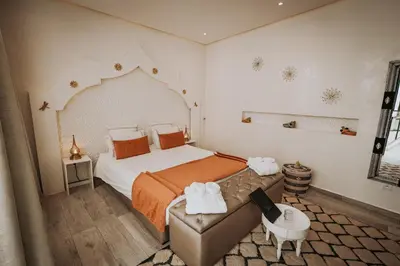 a bedroom with a large bed and a couch at RIAD NOLITA & SPA Kasbah in Marrakech