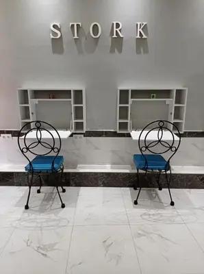 two chairs sitting in front of a store at Stork Marrakech Luxury Hostel in Marrakech