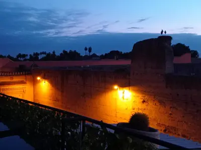a brick wall with lights on it at night at Stork Marrakech Luxury Hostel in Marrakech