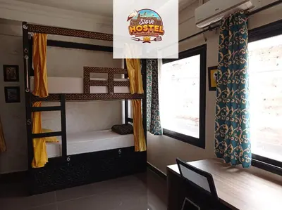 a room with two bunk beds and a table at Stork Marrakech Luxury Hostel in Marrakech