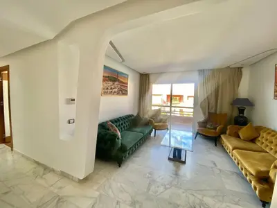 a living room with a couch and a table at RIAD GARDEN LUXURY AGDAL in Marrakech