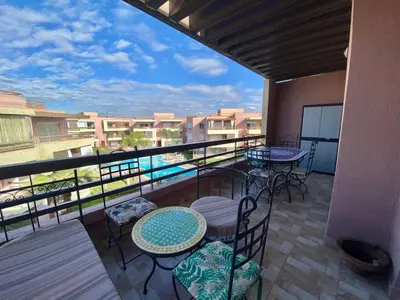 a balcony with tables and chairs and a view at RIAD GARDEN LUXURY AGDAL in Marrakech