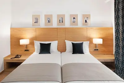 a bedroom with a large bed with two pillows at Hotel Riu Tikida Garden - Adults Only - All Inclusive in Marrakech