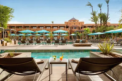 a resort with a pool and chairs and umbrellas at Hotel Riu Tikida Garden - Adults Only - All Inclusive in Marrakech