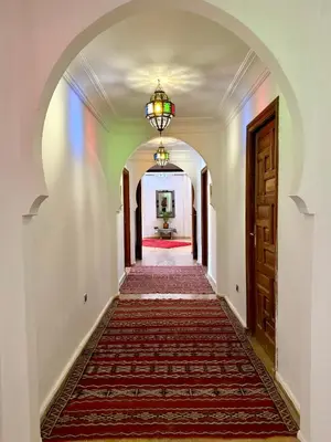 an archway leading to a hallway with a door at Villa Ross in Marrakech