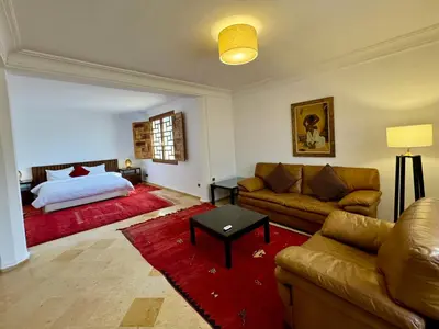 a living room with a couch and a bed at Villa Ross in Marrakech
